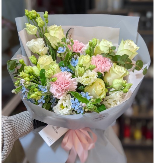 A mixed white bouquet with a splash of blue